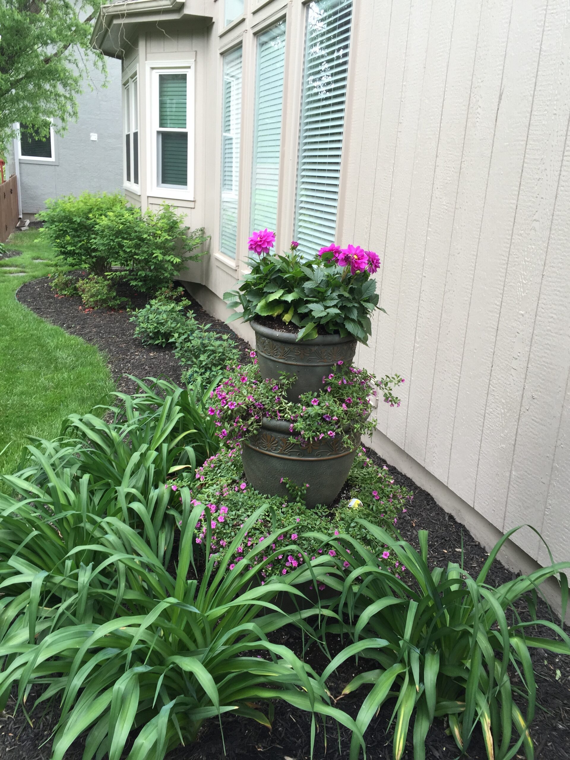 Flowers stacked vertically in three pots